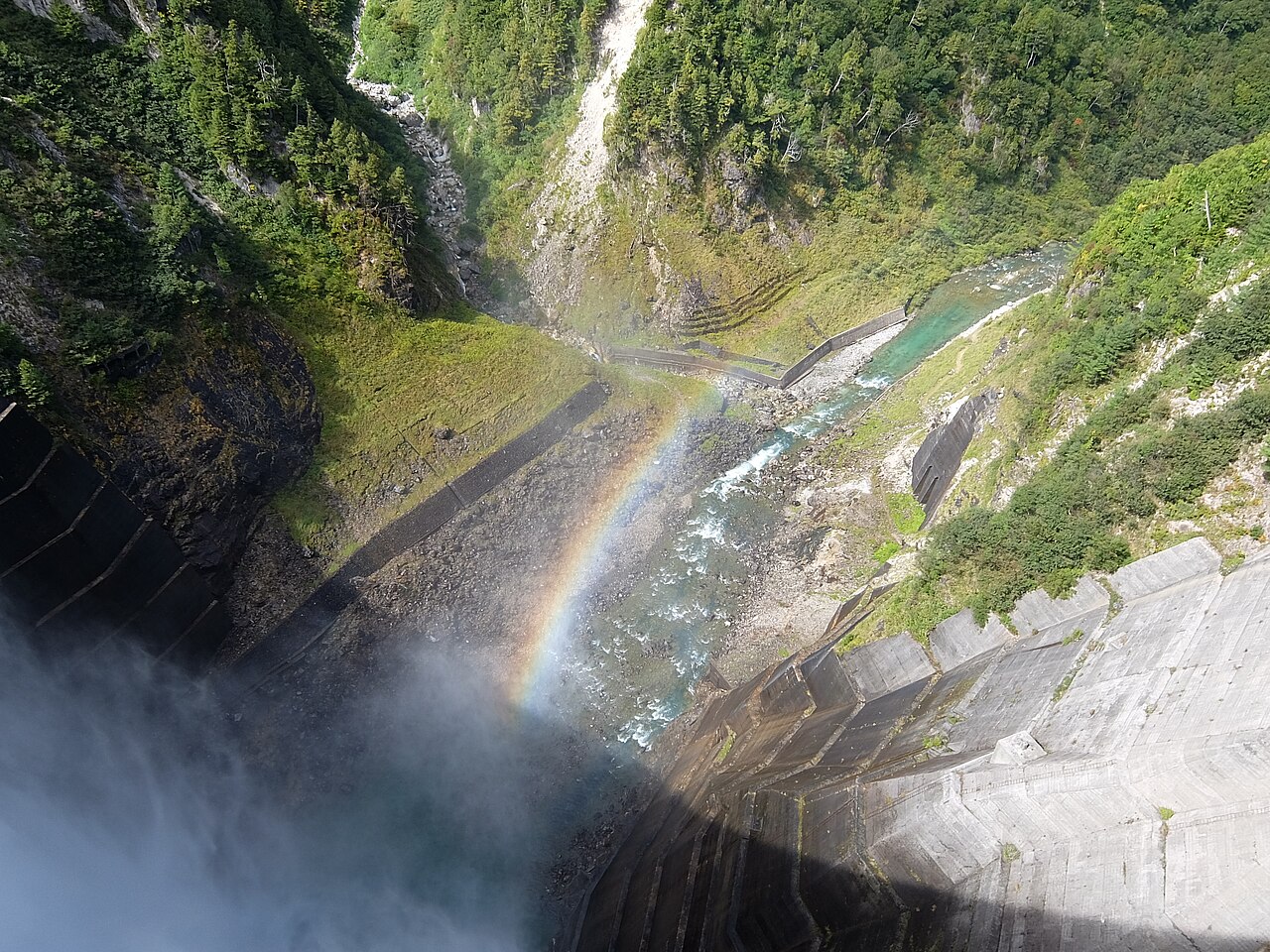 Kurobe Dam's water discharge seen from downstream in summer