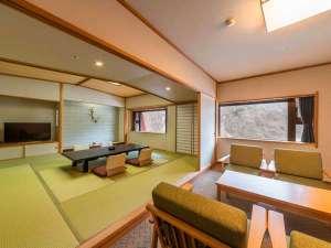 A tatami room with a sofa corner at Yamanoha