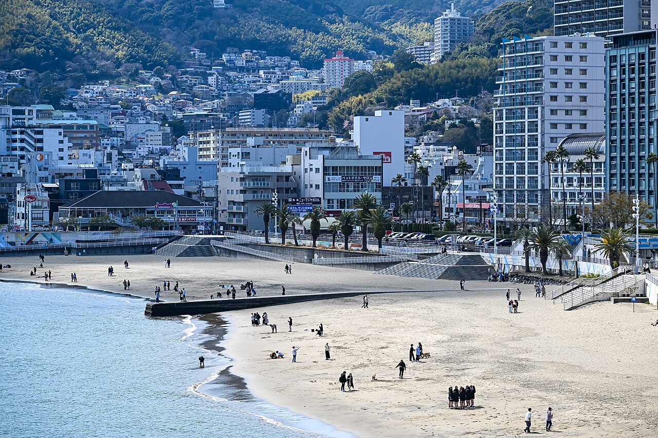 The palm-lined Atami Sun Beach seafront by day